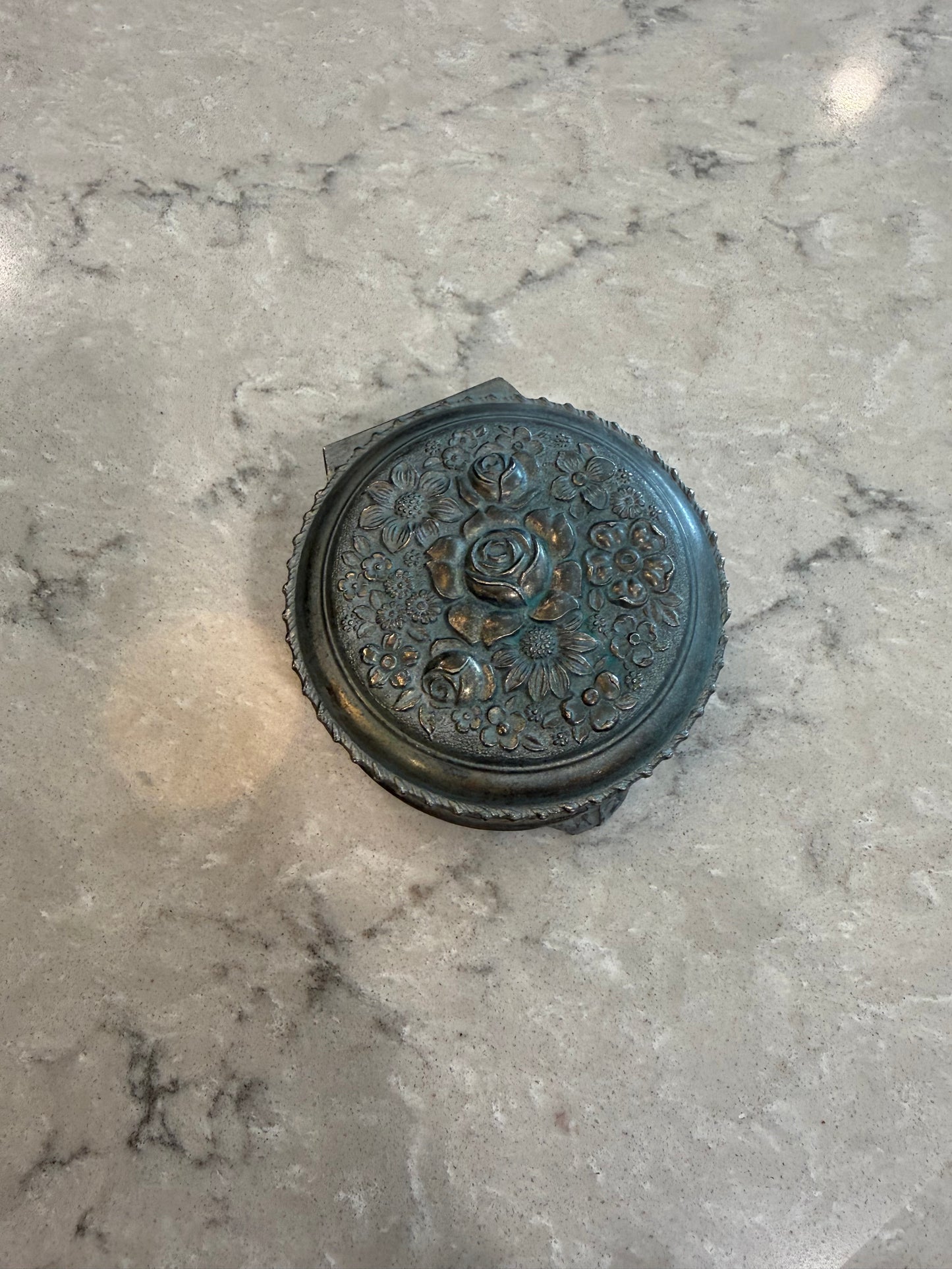 Metal trinket box with floral design
